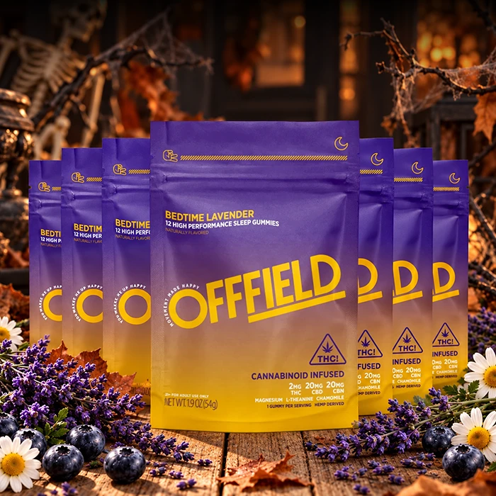 Offfield Bedtime Lavender gummies pouches arranged on a wooden surface with lavender, blueberries, and Halloween decorations.