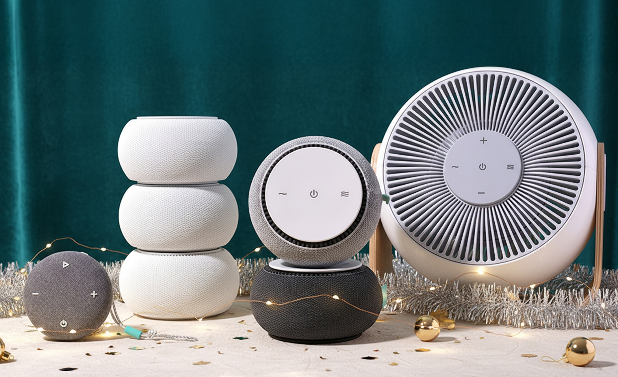 Assorted round speakers with festive decorations against a teal curtain backdrop.