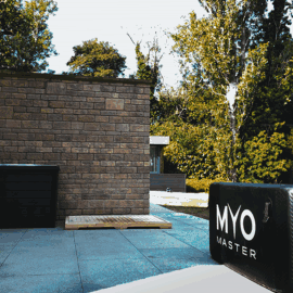 Outdoor patio with brick wall and MYO Master equipment.