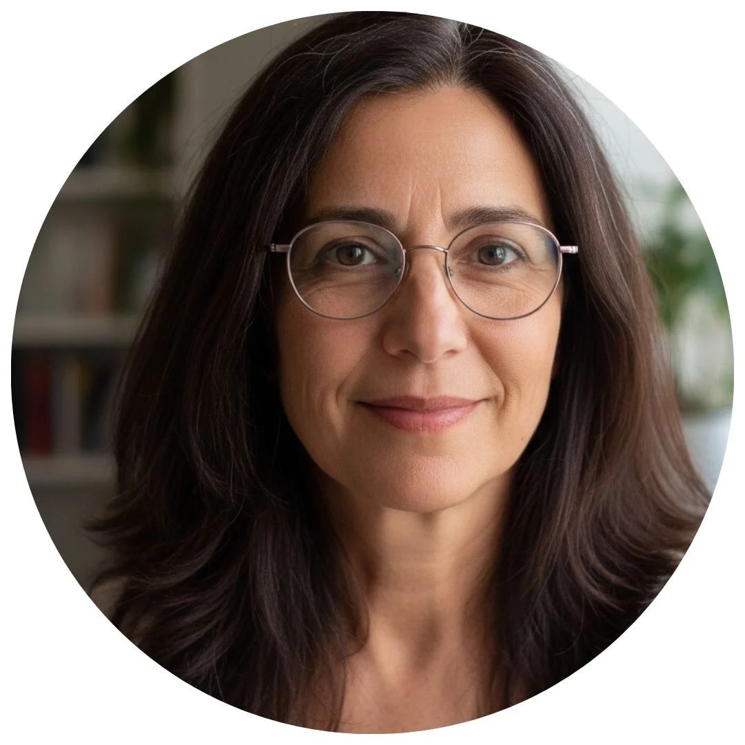 Woman with long hair and glasses in a circular frame.