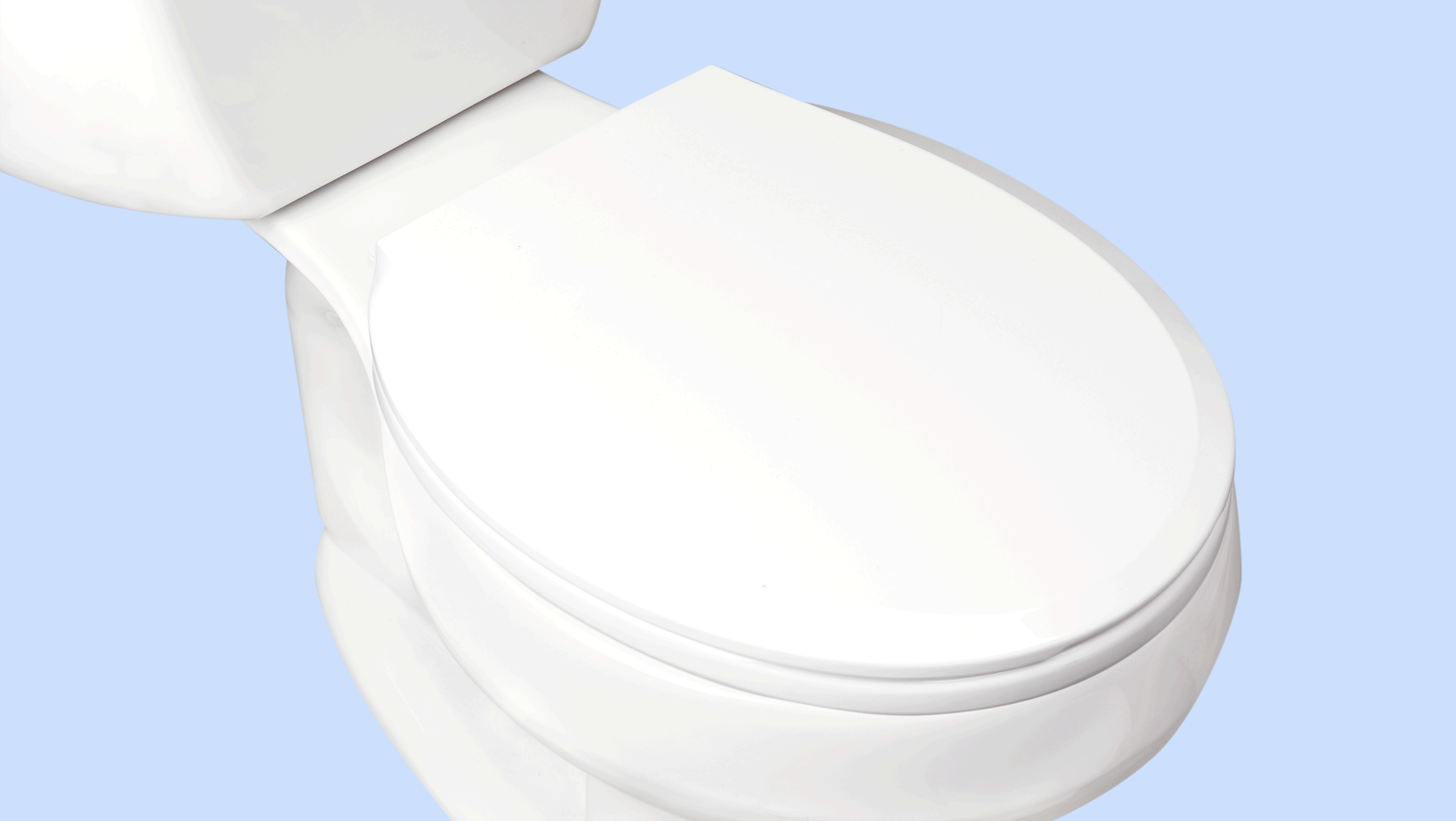 White toilet with closed lid on a light blue background.