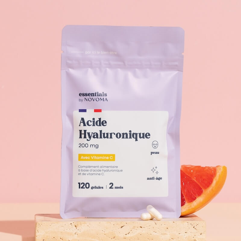 Package of hyaluronic acid supplement with Vitamin C next to grapefruit slice.