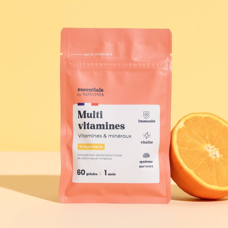A package of multivitamins with an orange slice on a yellow background.