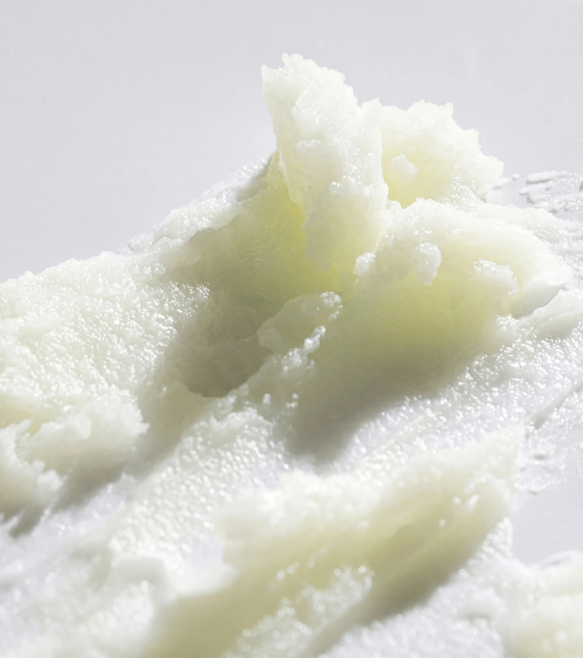 A close-up of dark purple fruits with water droplets, one sliced in half showing its juicy interior.