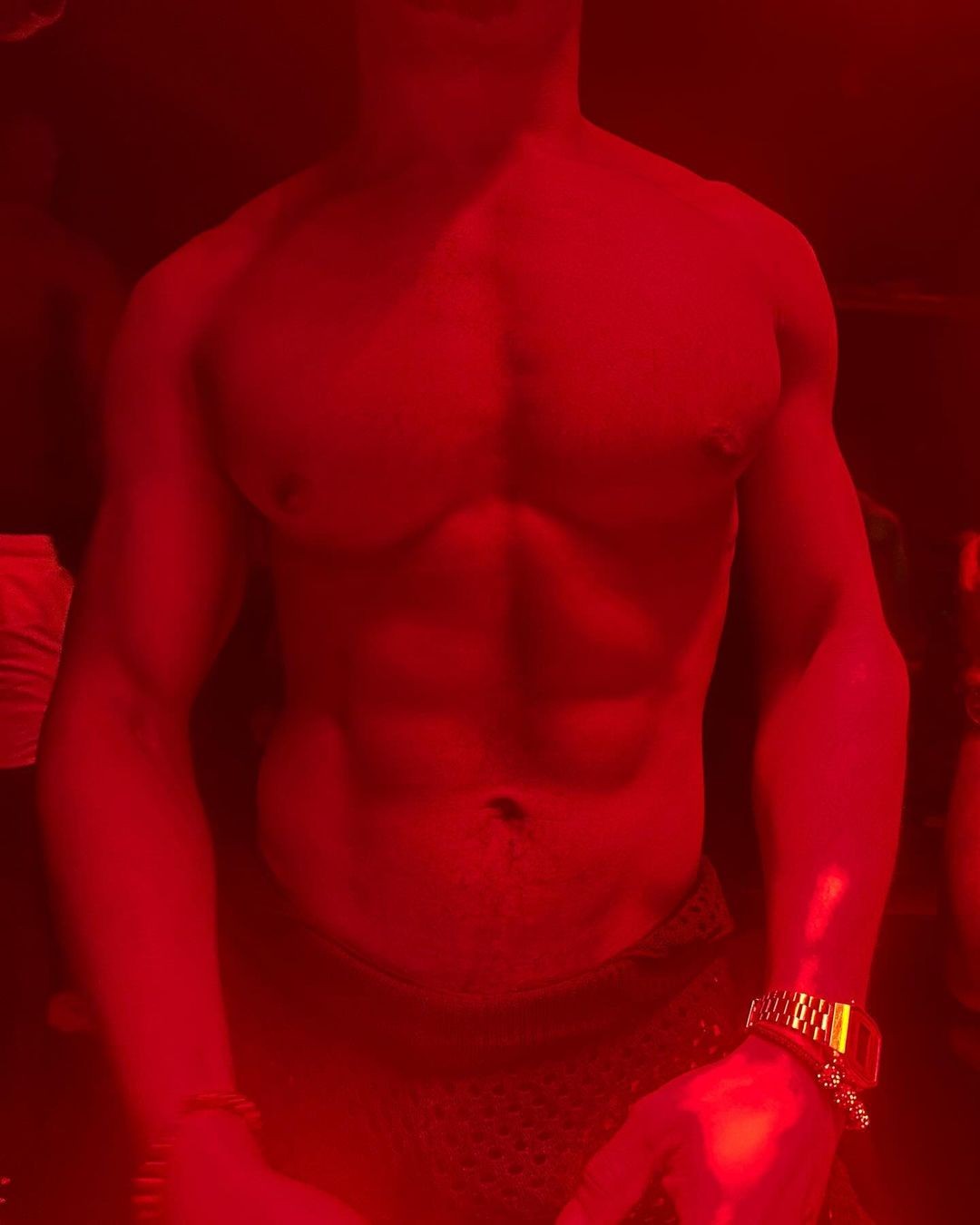 Person running with orange shoes and red shorts on a road.