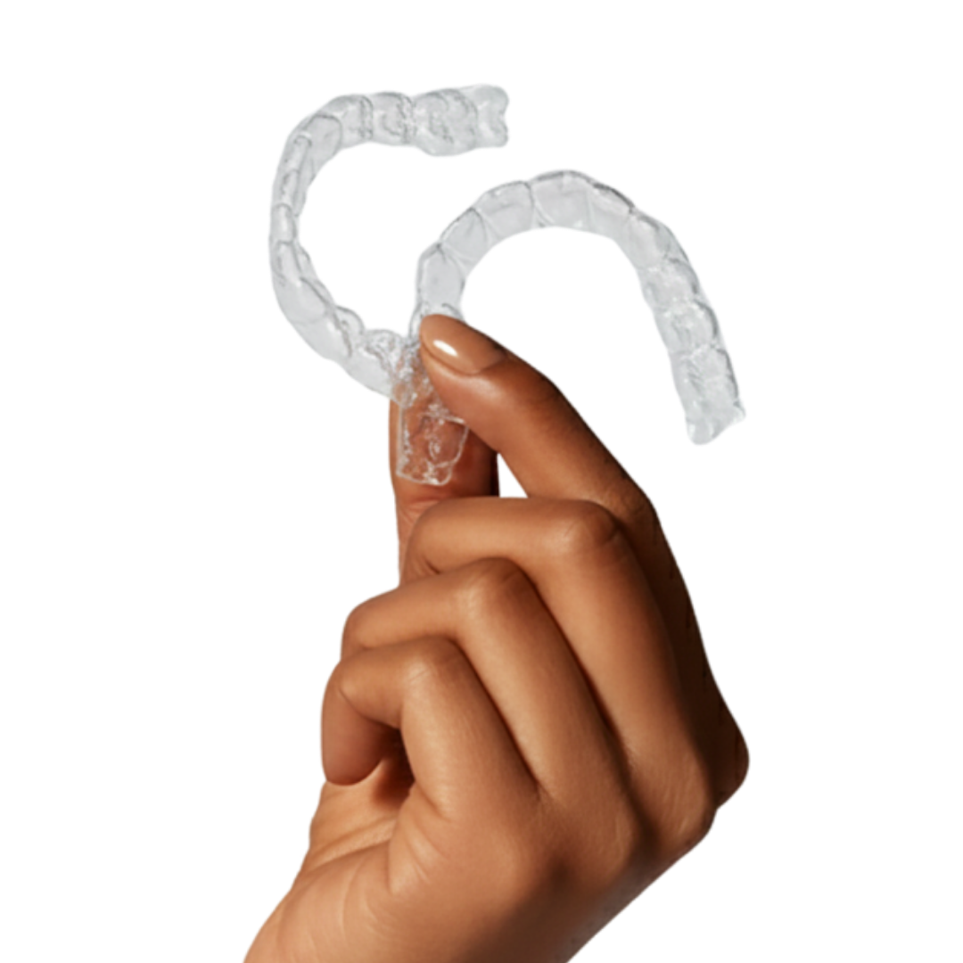 A hand holding a set of clear plastic dental aligners against a black background.