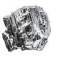 A rough nugget of a silver-colored, crystalline metal set against a solid green background.