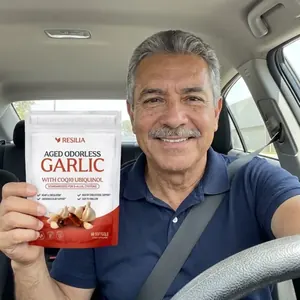 Resilia customer holding the Aged Garlic pouch