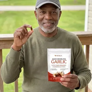 Resilia customer holding the Aged Garlic pouch