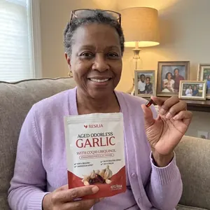 Resilia customer holding the Aged Garlic pouch