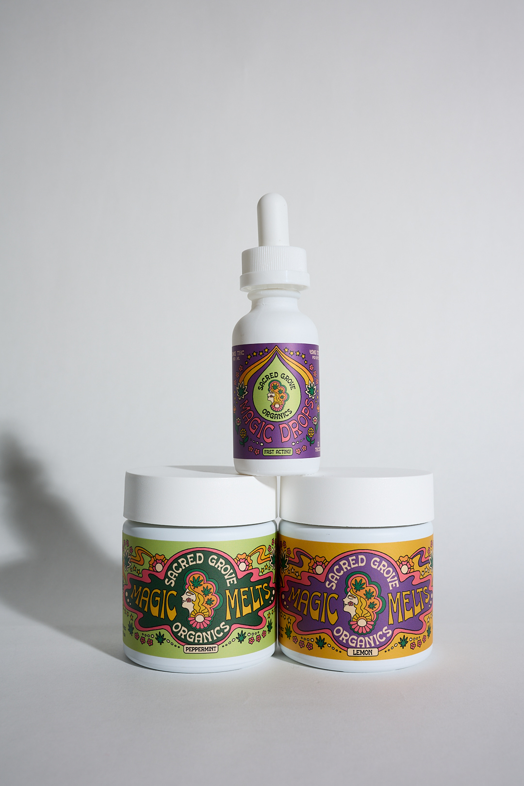 Three colorful jars and a dropper bottle with decorative labels.