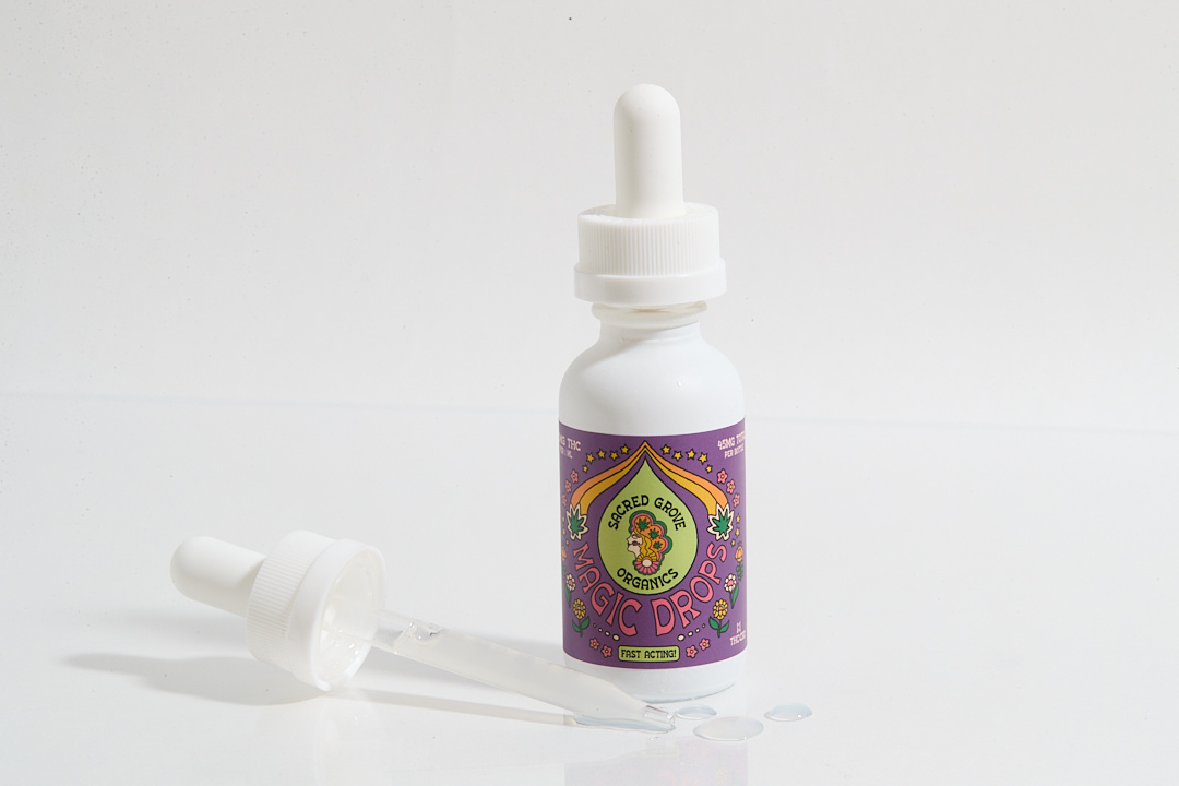 A bottle of 'Magic Drops' with a dropper on a white background.