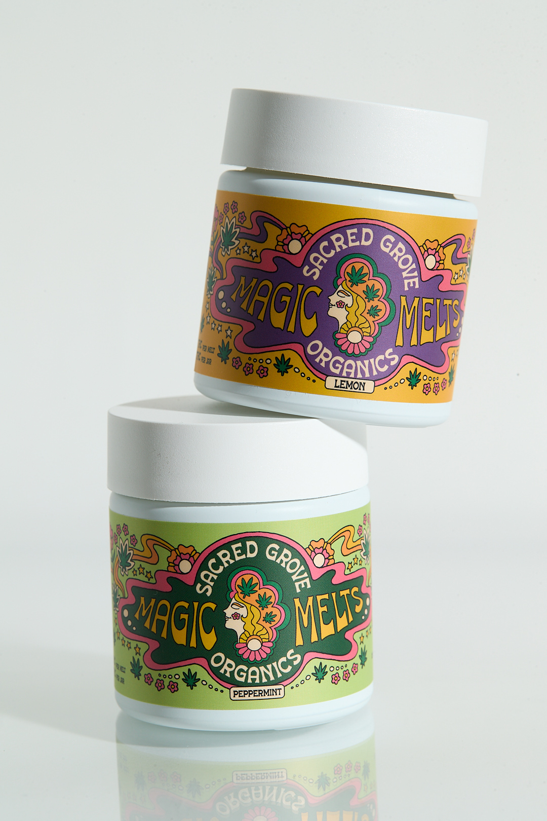 Two jars labeled 'Sacred Grove Organics Magic Melts' with colorful designs.