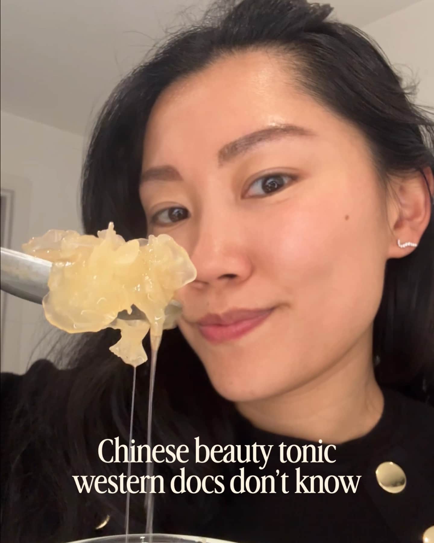 A woman holds up a spoon with a translucent, gelatinous substance to the camera.