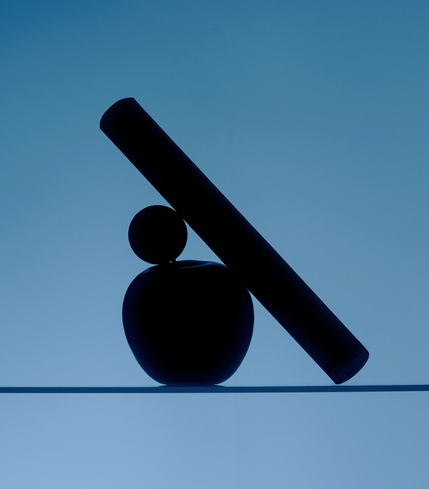 Silhouette of geometric shapes against a blue background.