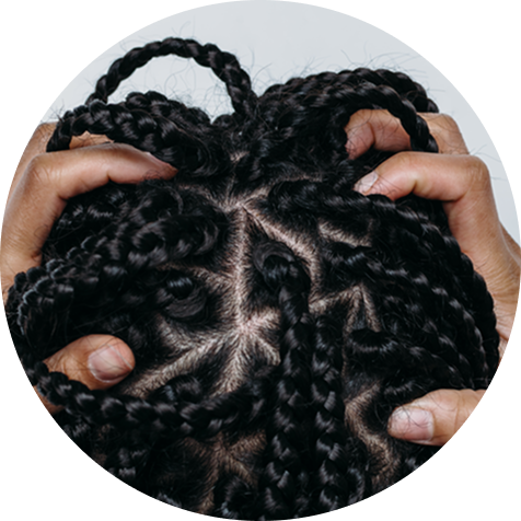 Hands holding head with braided hair.