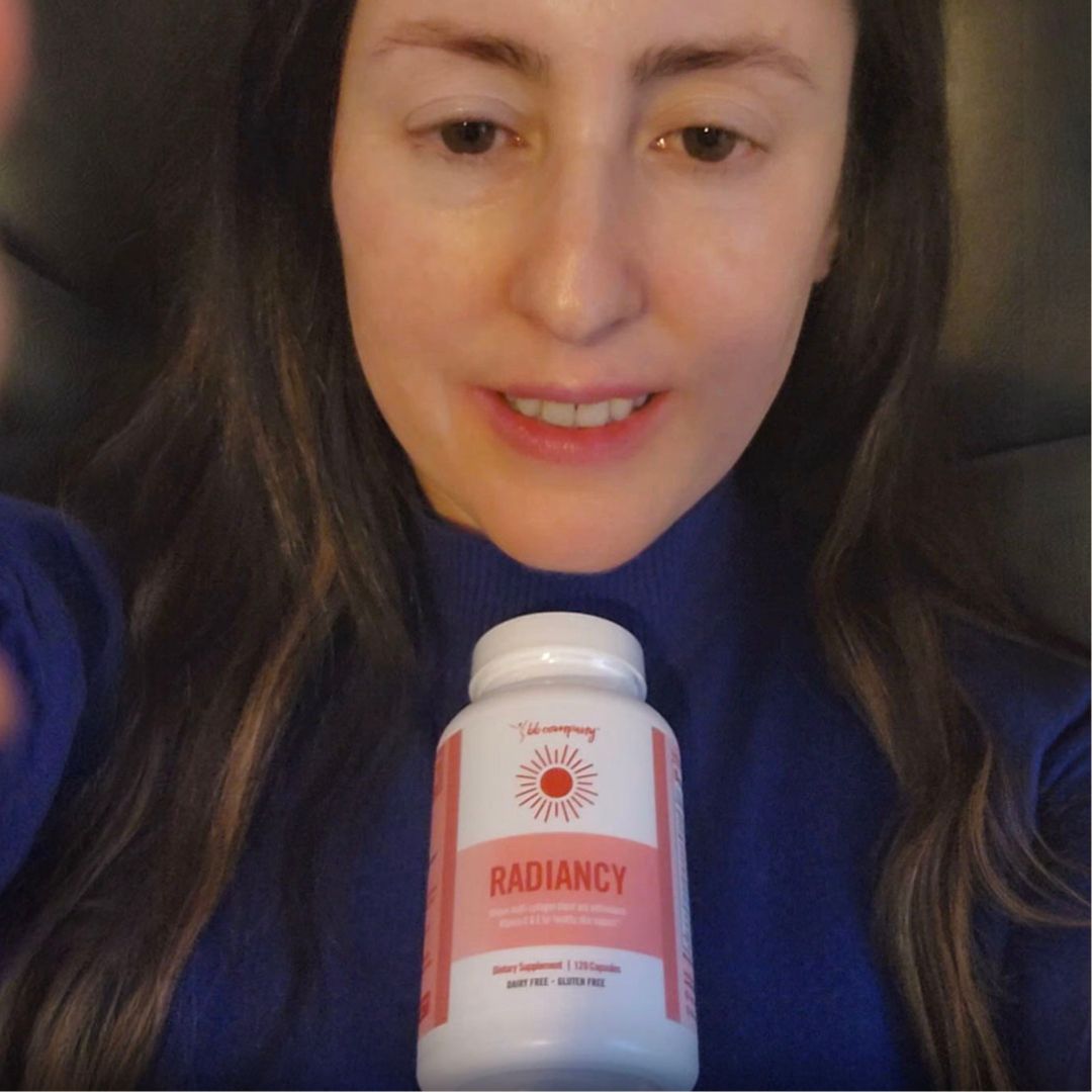 A woman in a blue sweater holds up a white bottle of supplements labeled 'Radiance'.