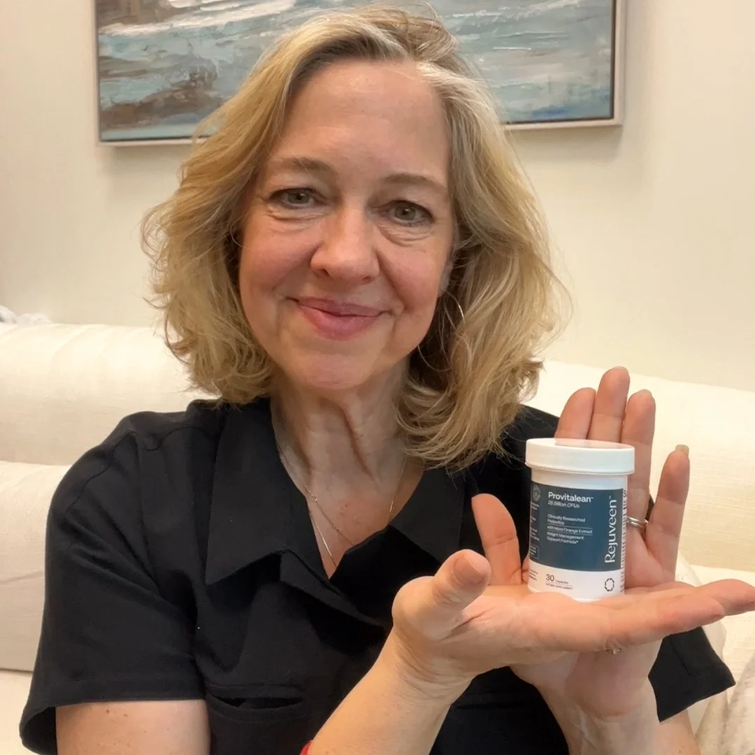 A smiling woman in a black shirt holds a white bottle of Provitalean supplements in her hand.