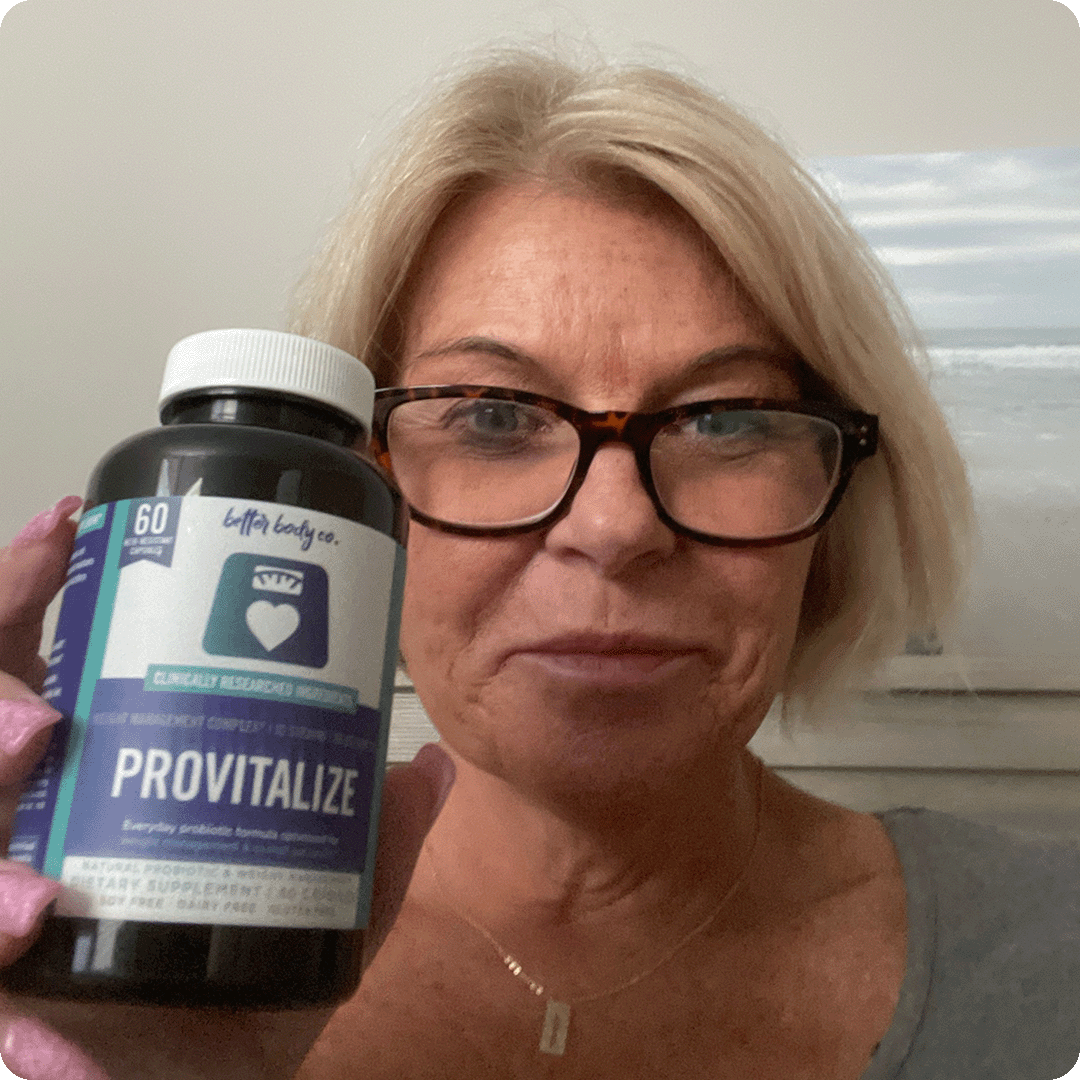 A woman with blonde hair and glasses holds up a bottle of Provitalize supplements.
