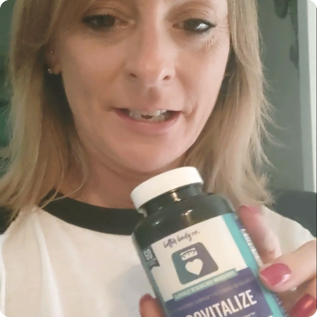 A woman with blonde hair holds up a bottle of Provitalize supplements.