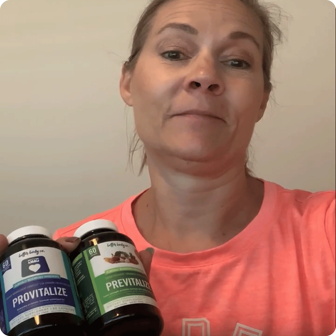 A woman in a pink t-shirt holds up two bottles of Provitalize and Previtalize supplements.