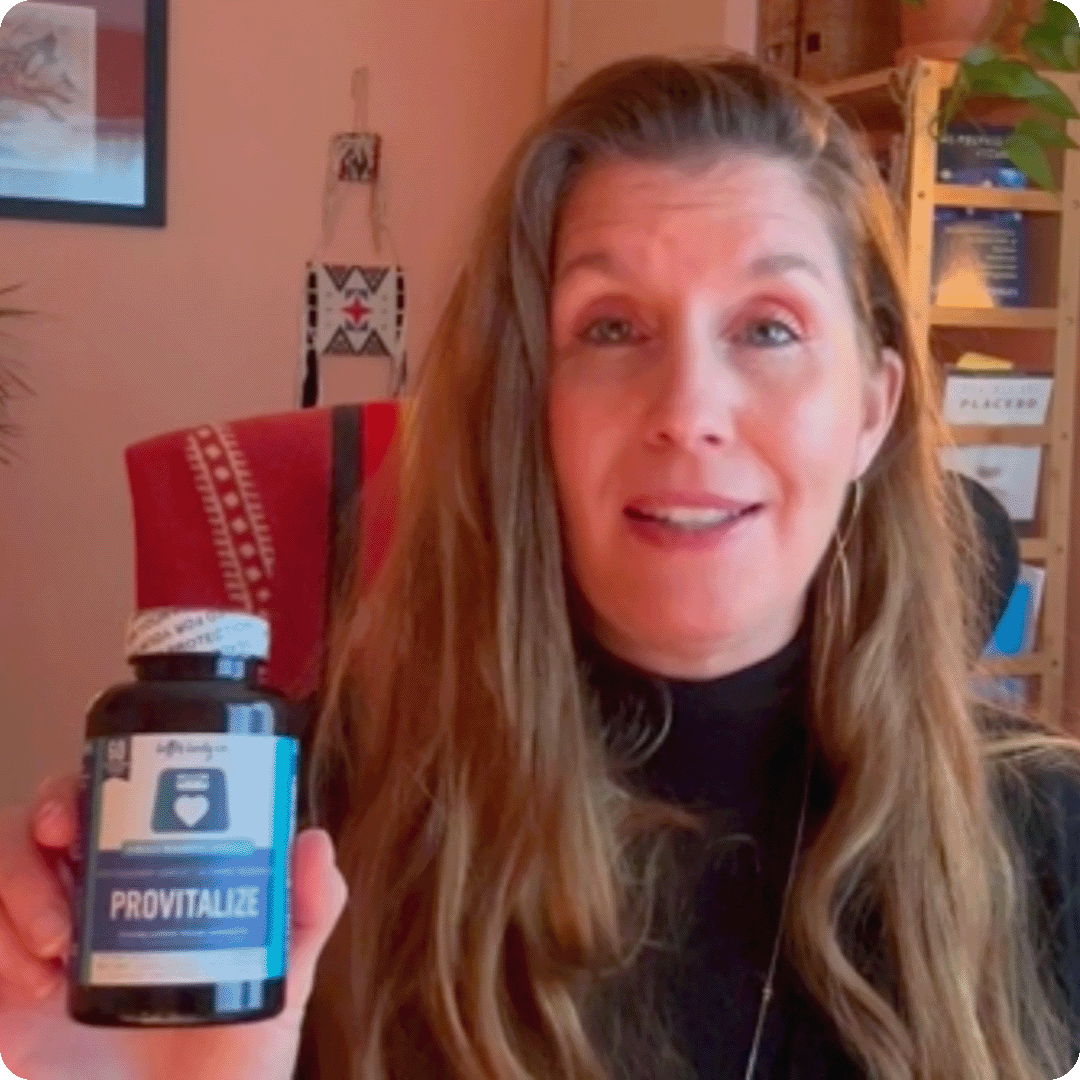 A smiling woman with long brown hair holds up a bottle of Provitalize supplements.