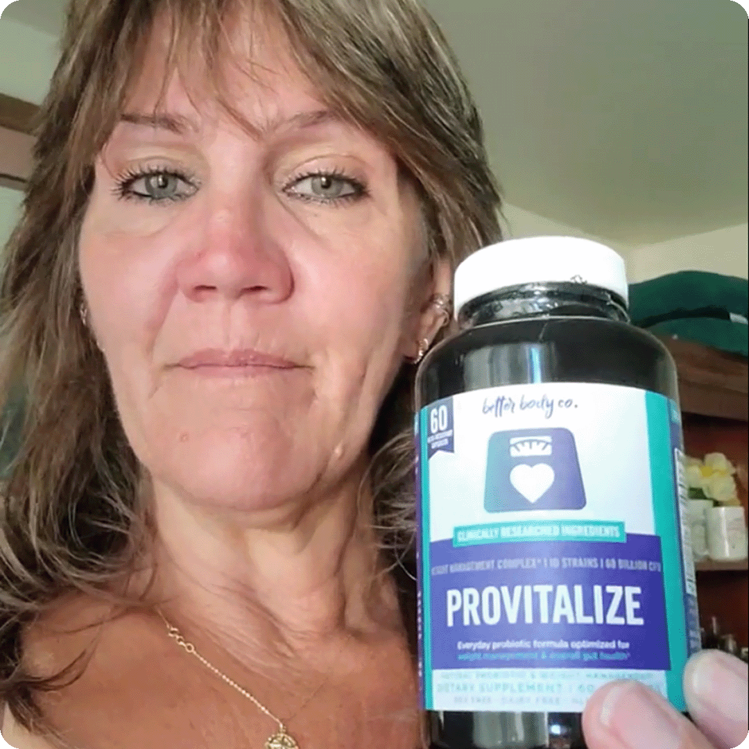 A woman with light brown hair holds up a bottle of Better Body Co. Provitalize supplements.