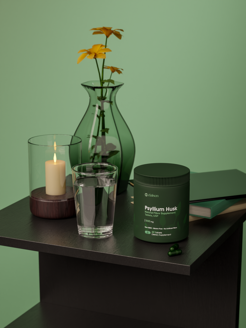 Table with flowers, candle, glass of water, supplements, and books.