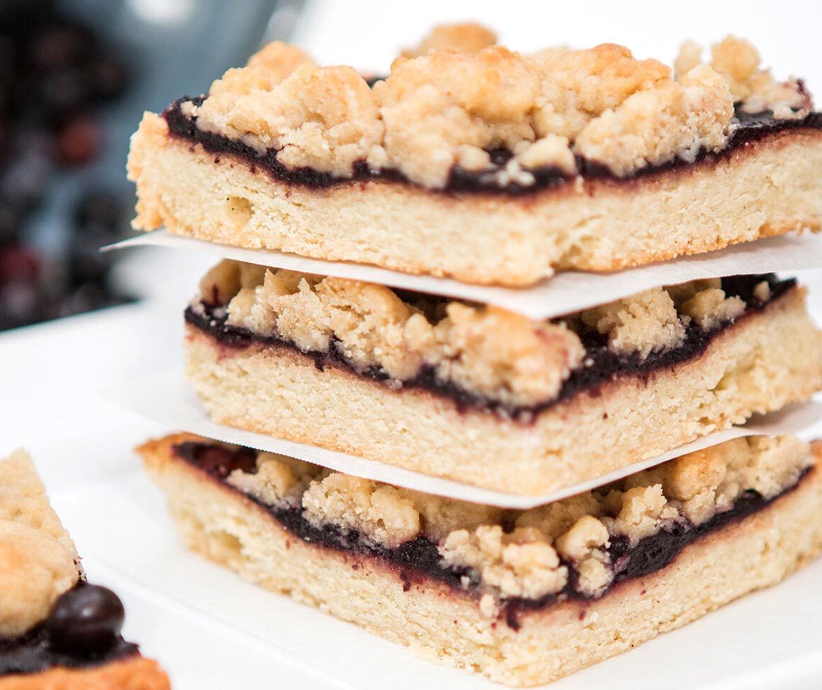 Three stacked crumb bars with a fruit filling and crumbly topping.