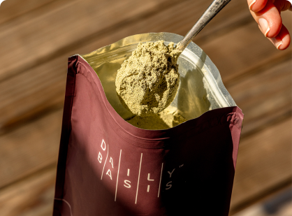 A box of DailyBasis Replenish nutrient support supplement with a single-serving packet leaning against it.