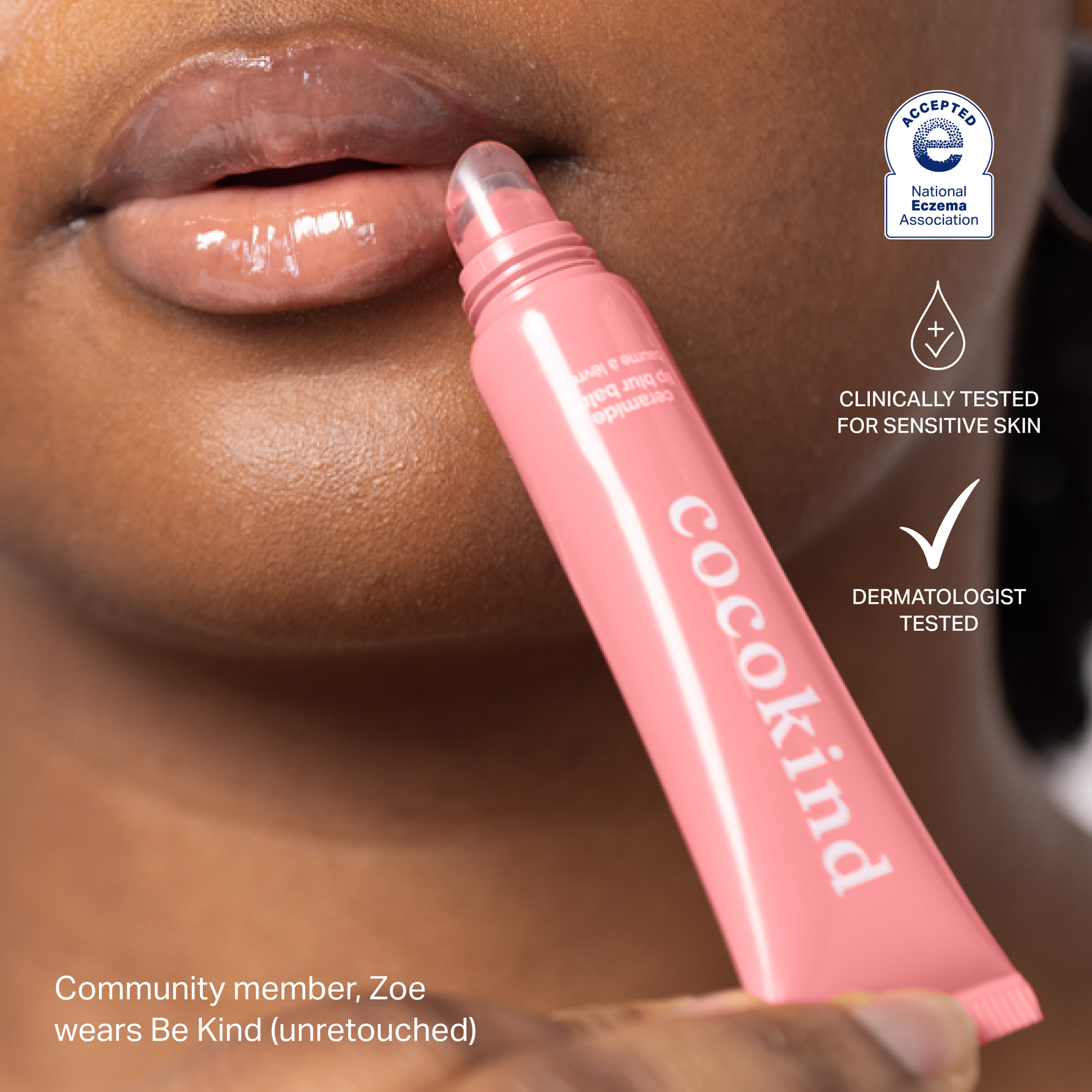 Close-up of a person applying pink lip balm labeled 'cocokind' to their lips.