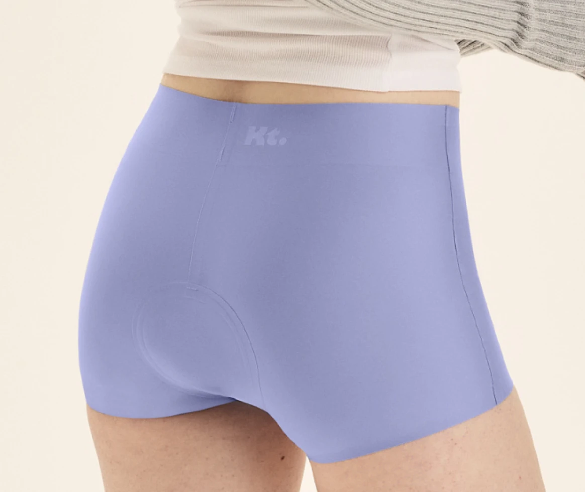 Person wearing light purple shorts with a white top.