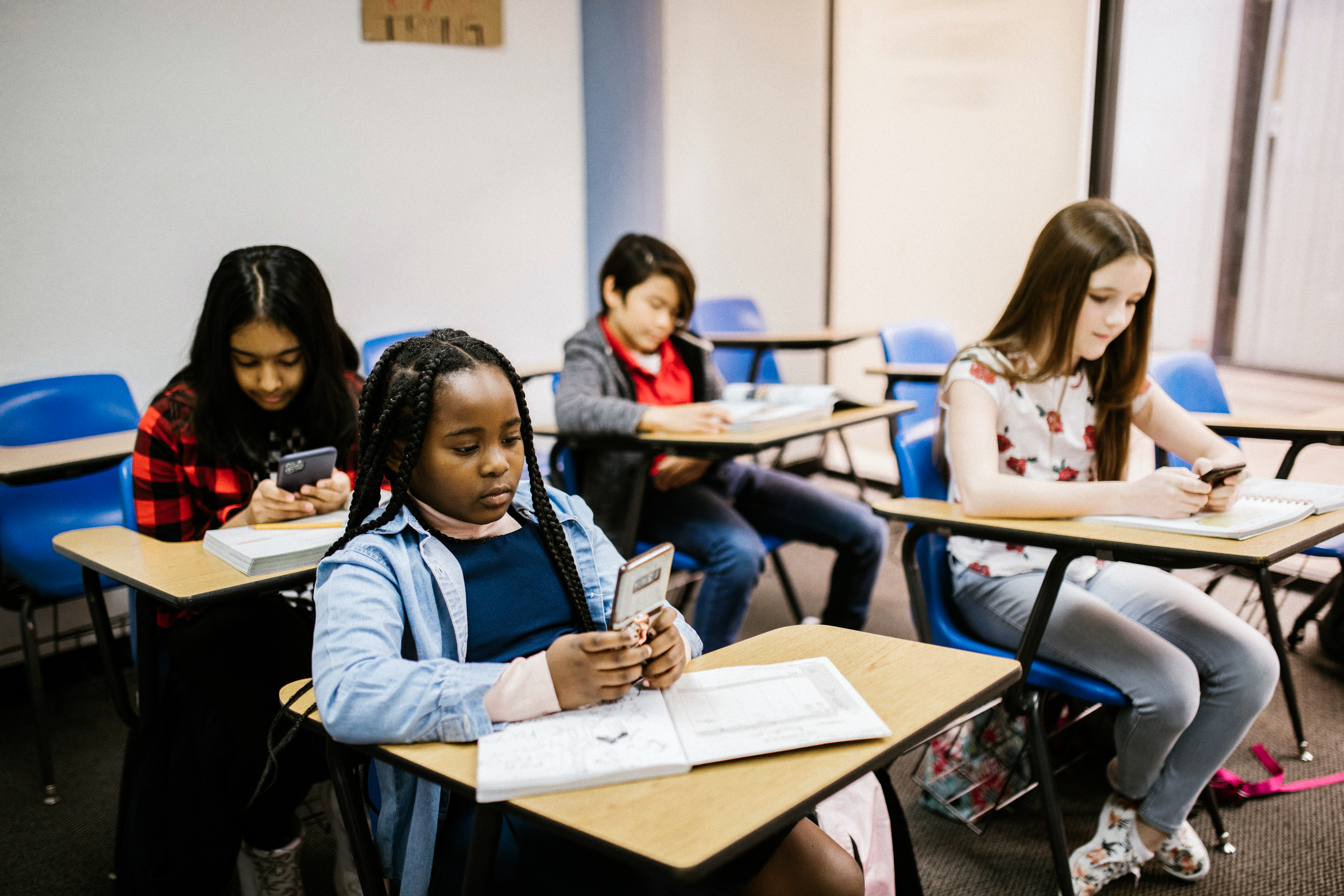Students in class on their phones

