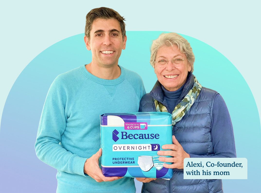 Two people holding a package of protective underwear.