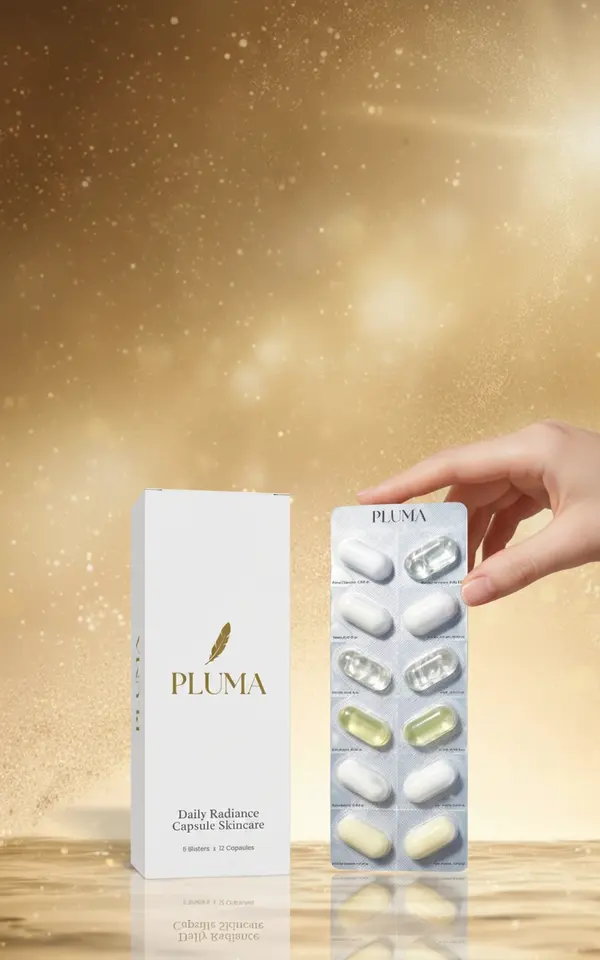 A hand holding a blister pack of Pluma skincare capsules next to the product box on a reflective surface.