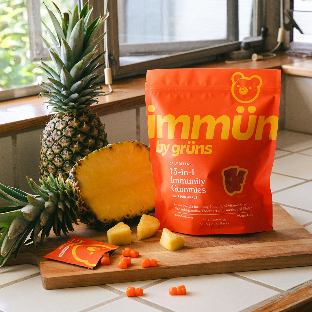 Red bag of immunity gummies with pineapples on a kitchen counter.