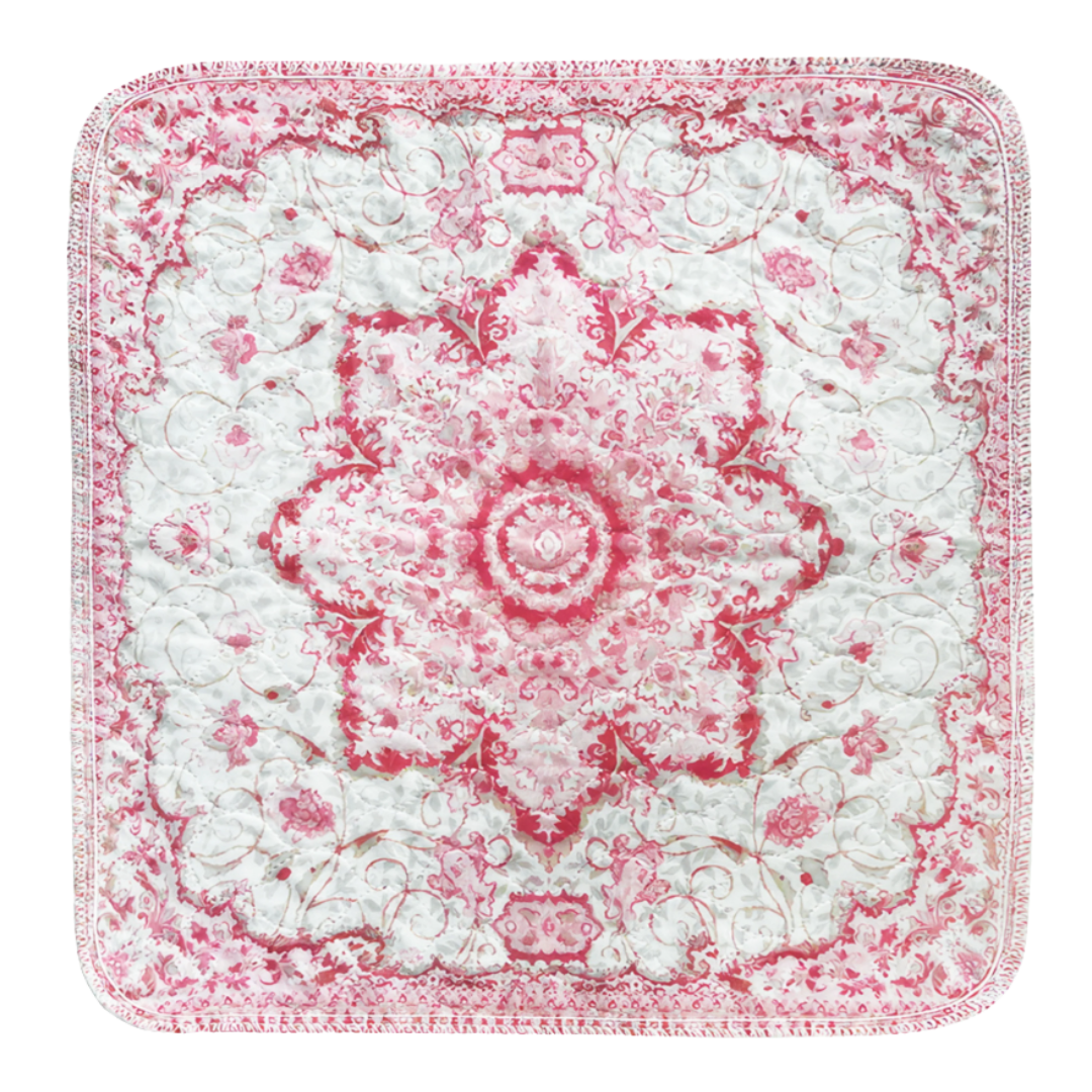 Square quilt with intricate pink and white floral patterns.