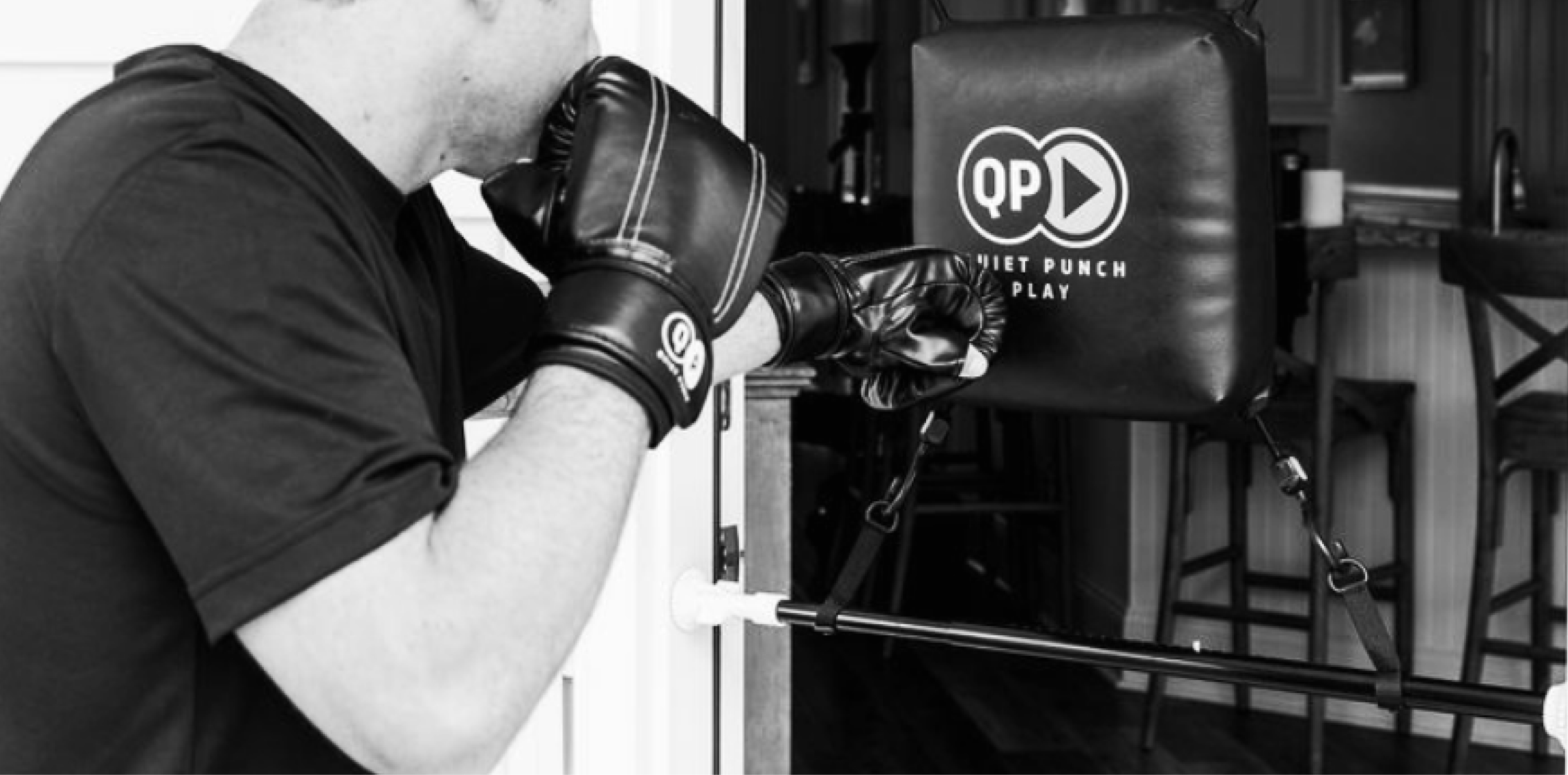 Person punching a Quiet Punch bag mounted in a doorway.