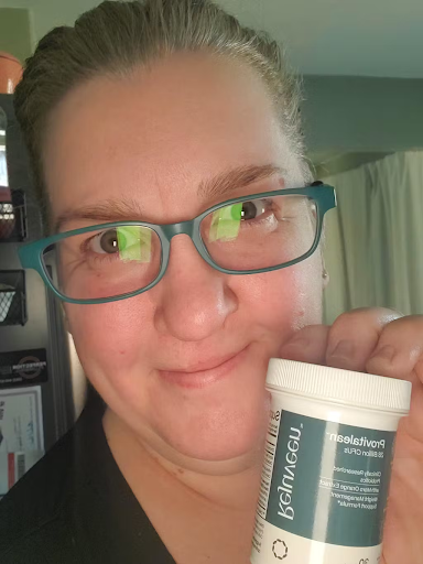 Person holding a container with a focused expression.