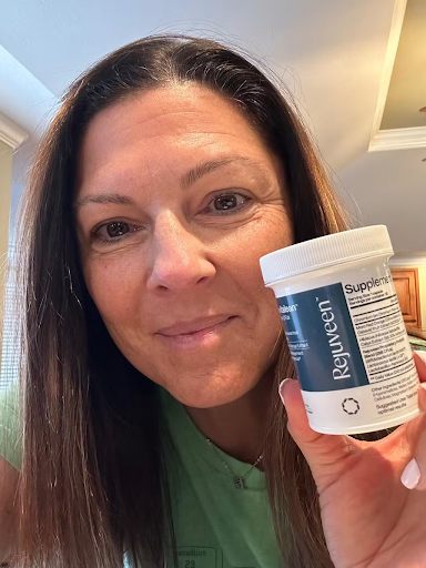 Woman holding a container labeled 'Rejuveen Supplement' in her hand.