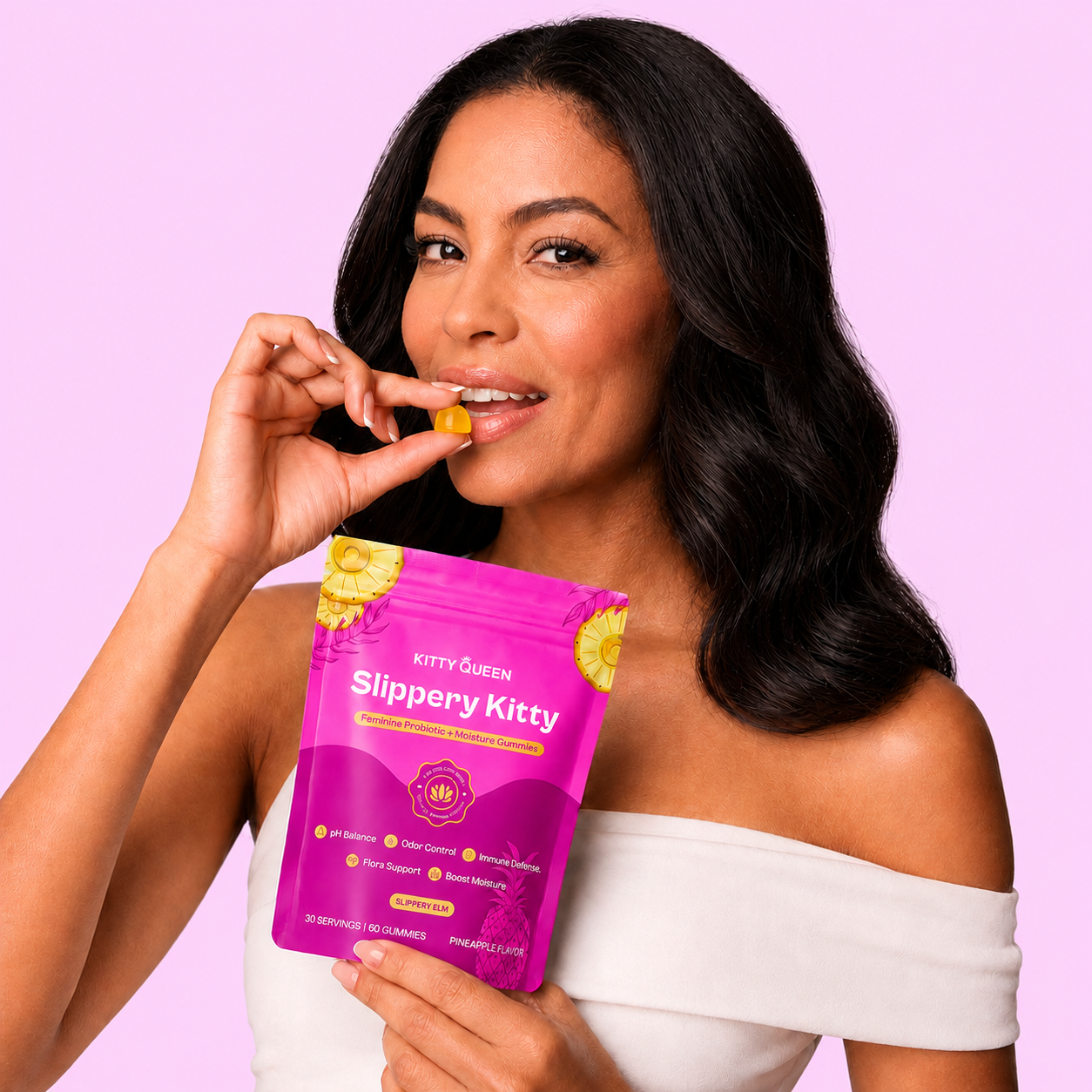 A woman holds a pink pouch of Slippery Kitty gummies and is about to eat one.