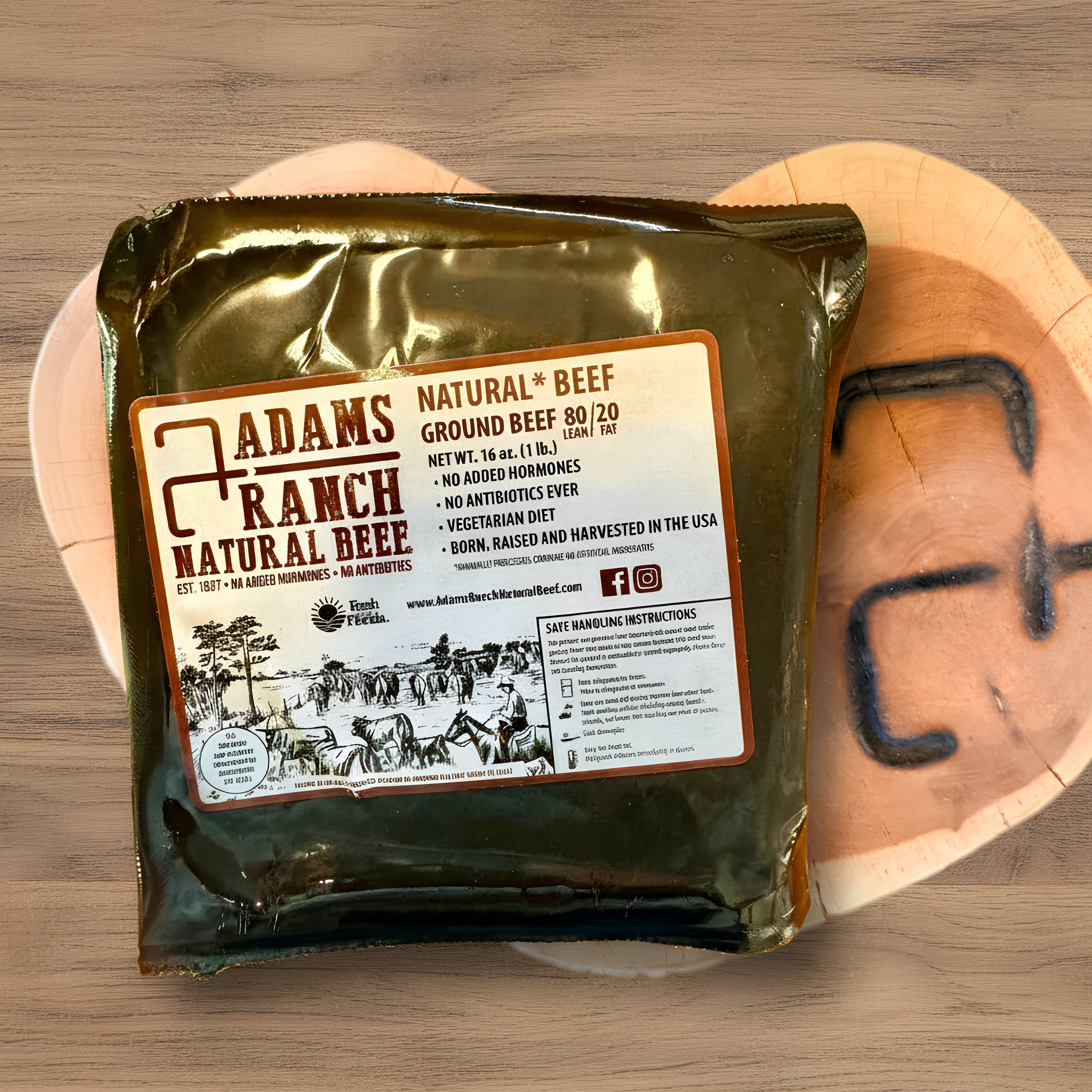 A package of Adams Ranch Natural Beef ground beef on a branded wooden surface.