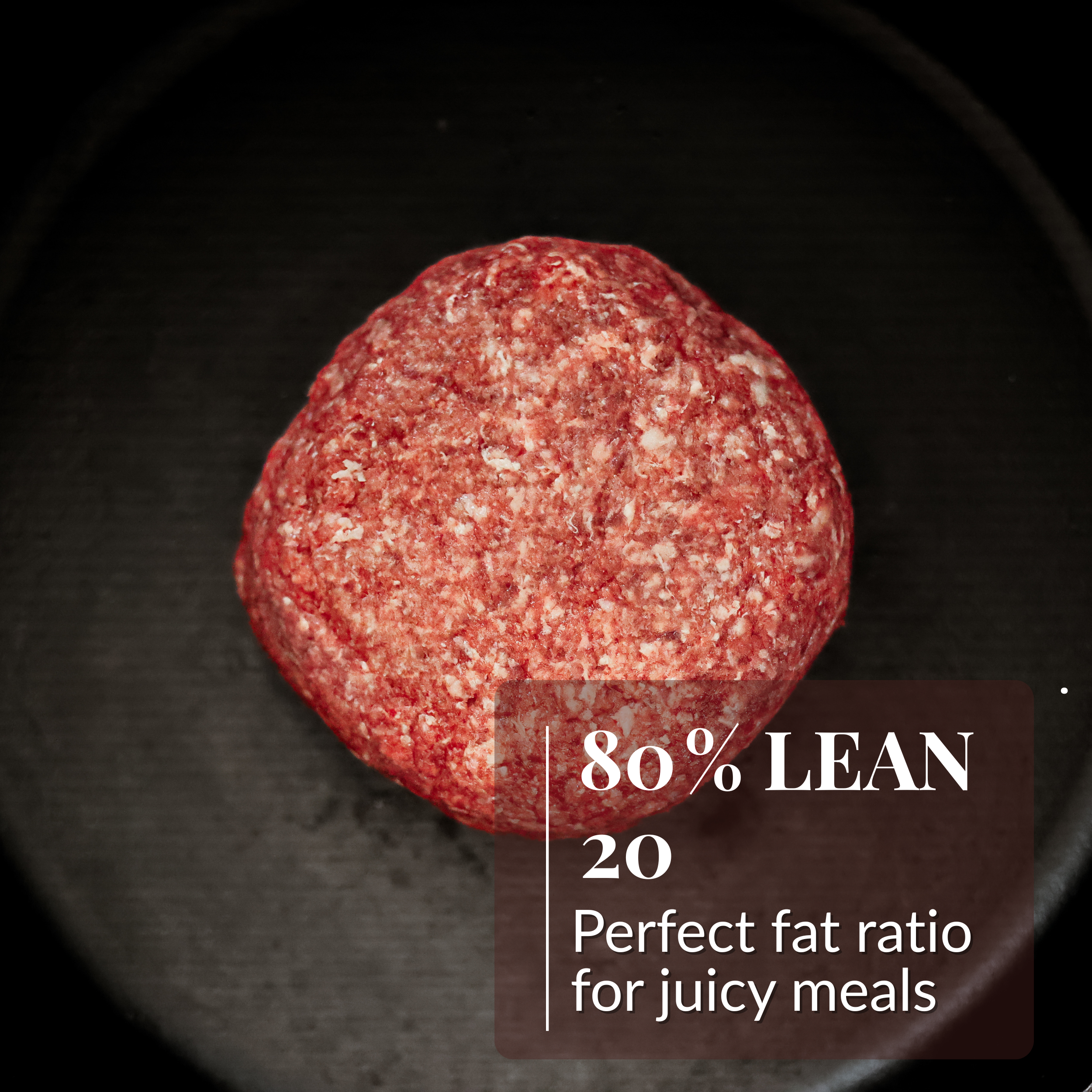 A top-down view of a ball of raw ground meat in a dark pan, labeled 80% lean.