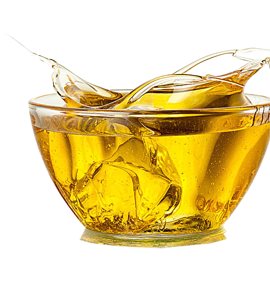 Glass bowl filled with golden liquid and a spoon.