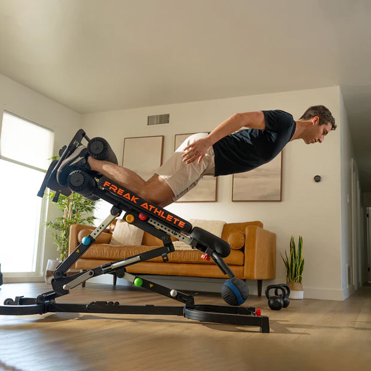 Person using a fitness machine in a living room.