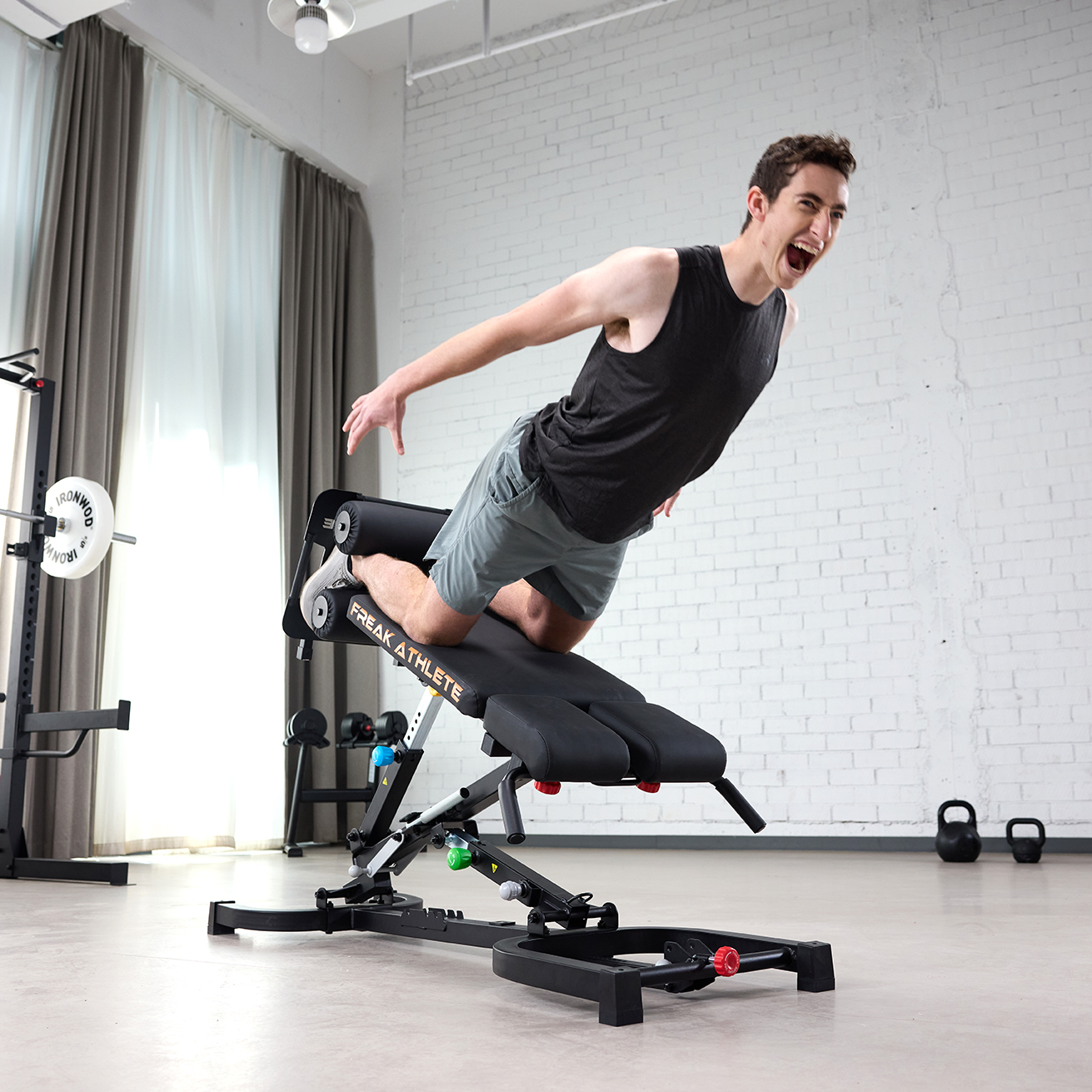 Person exercising energetically on fitness equipment in a bright gym setting.