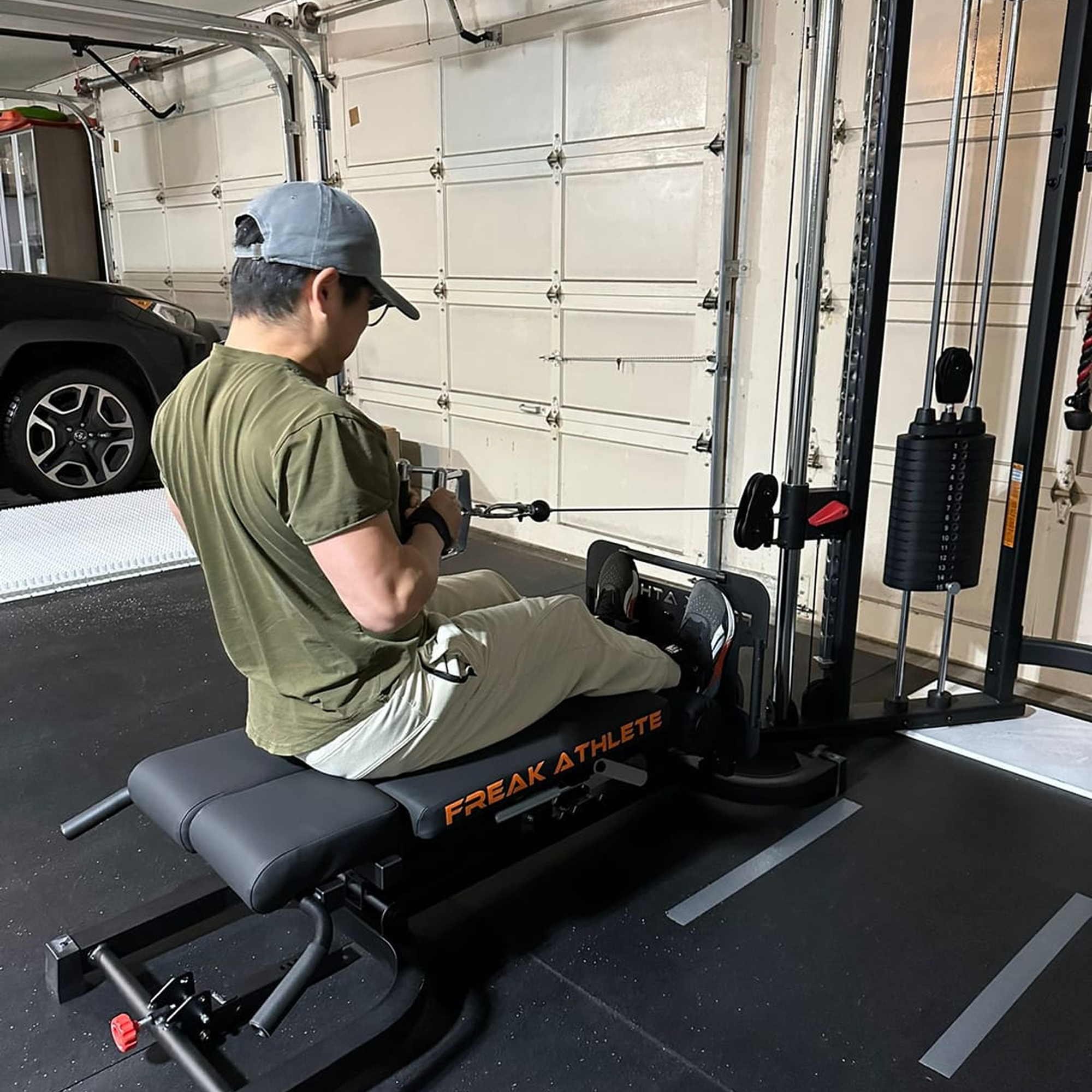Person using a rowing machine in a garage gym.