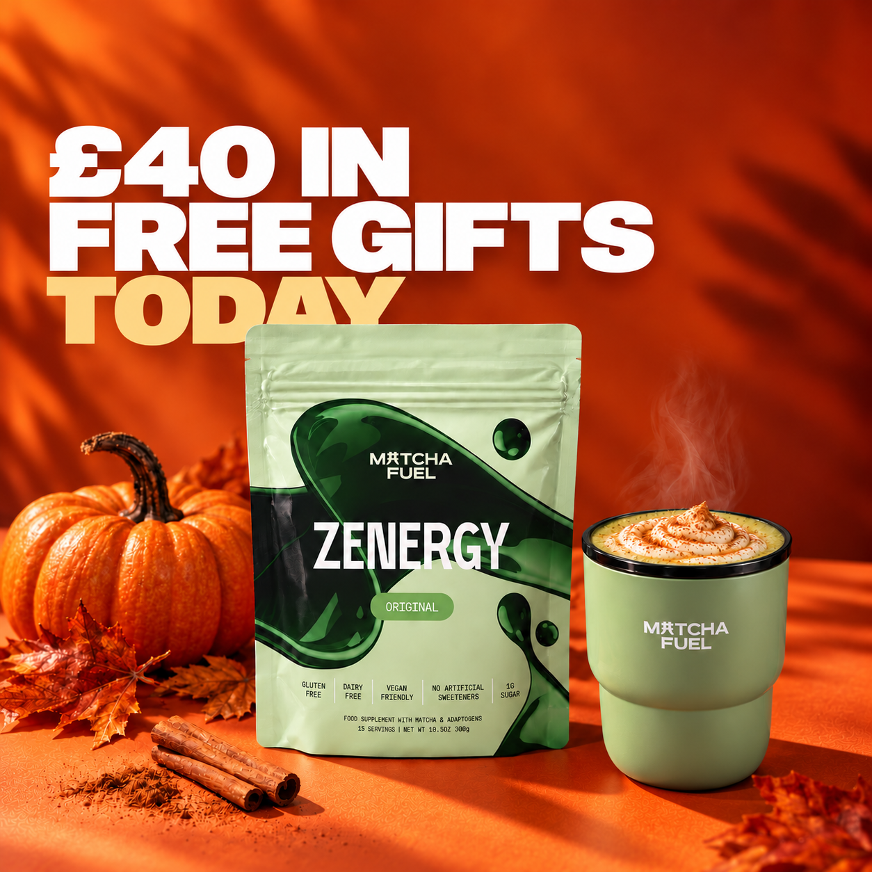 A pouch of Matcha Fuel Zenergy next to a pumpkin, cinnamon sticks, and a steaming matcha latte.