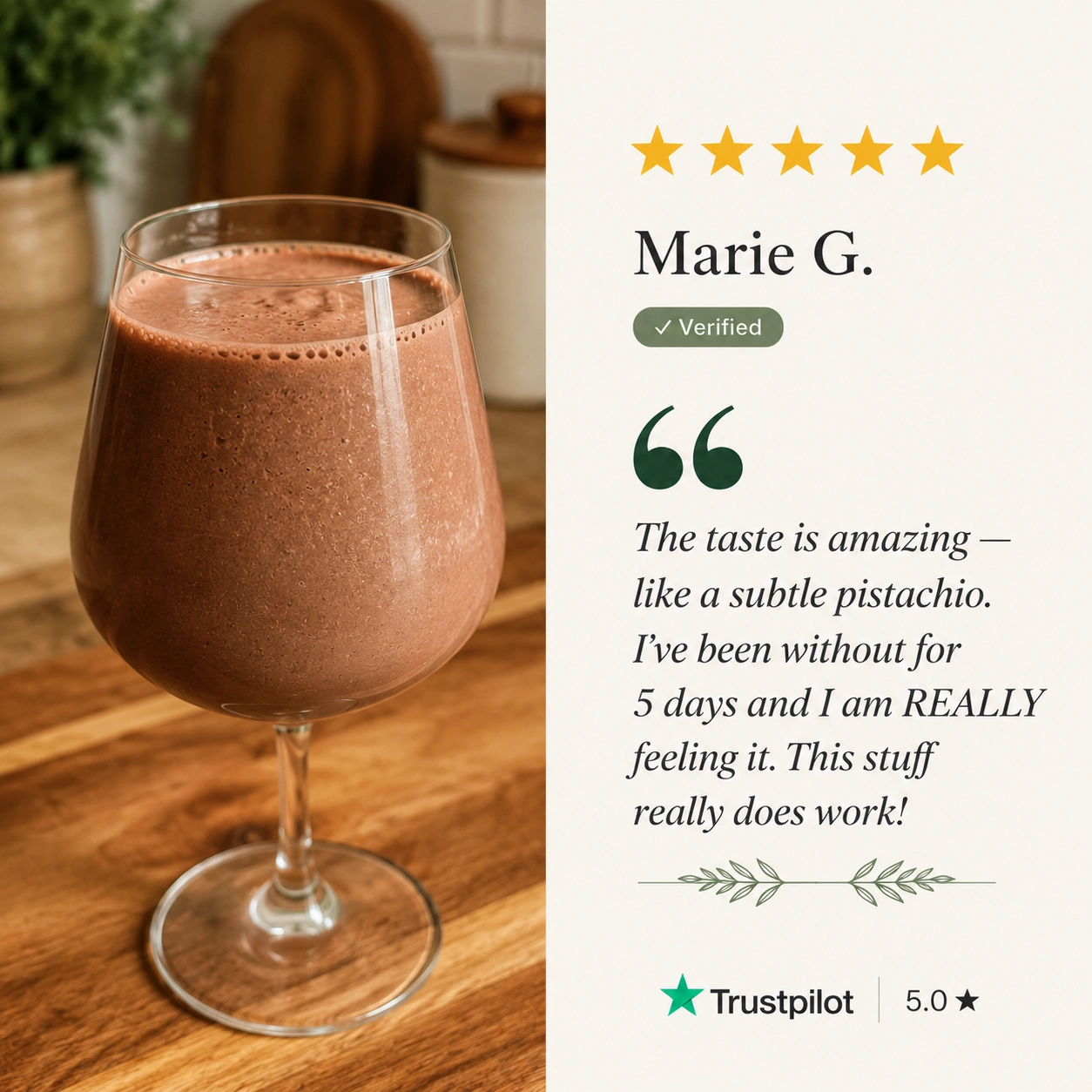 A brown smoothie in a wine glass sits on a wooden counter next to a five-star customer review.