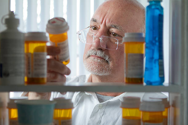 Person looking at prescription bottles on a shelf.